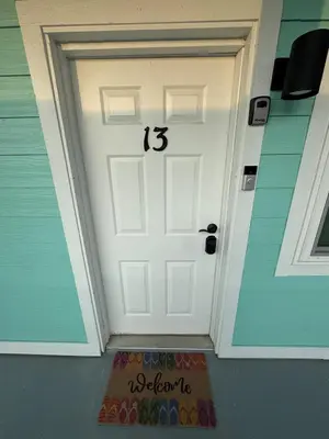 a white door with the number on it at Beach Across Street, Walk to Restaurants, 2 Pools, Beach Gear in Panama City Beach