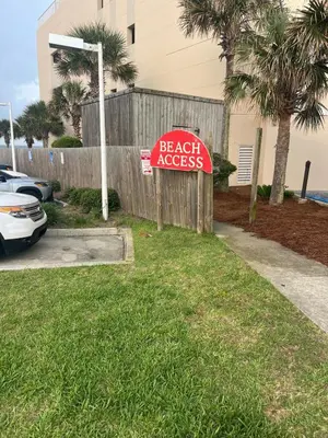 a sign that reads beach access in front of a fence at Beach Across Street, Walk to Restaurants, 2 Pools, Beach Gear in Panama City Beach