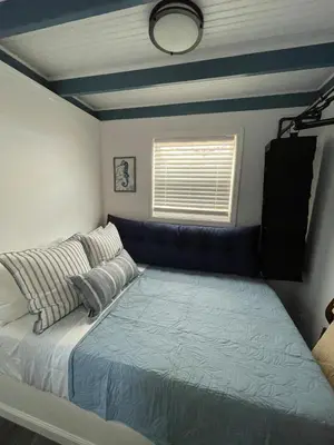 a bedroom with a bed and a couch at The Blue Umbrella at the Beach in Panama City Beach