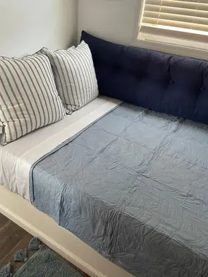 a bed with a blue couch in a room at The Blue Umbrella at the Beach in Panama City Beach