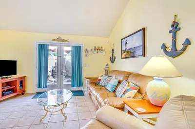 a living room with a couch and a table at Cheerful 1-bedroom townhouse with spacious loft in Panama City Beach