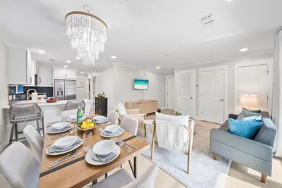 a dining room and living room with a table and chairs at Beachside Villas 811 in Watersound Beach