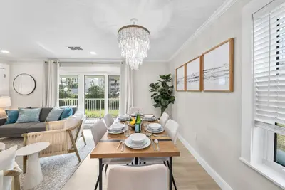 a dining room and living room with a table and chairs at Beachside Villas 811 in Watersound Beach