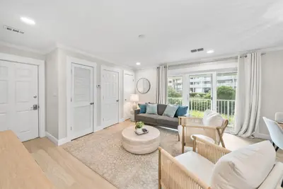 a living room with a couch and a table at Beachside Villas 811 in Watersound Beach