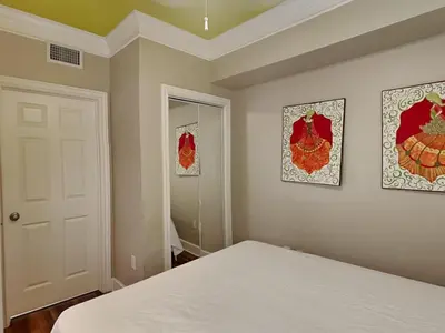 a bedroom with a bed and two pictures on the wall at Majestic Beach Towers II #1806 in Panama City Beach