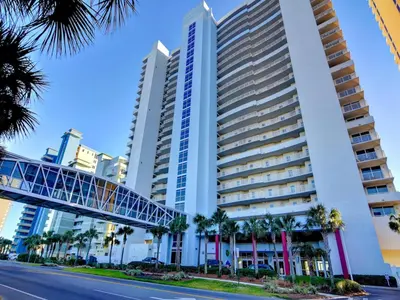 a tall building with a bridge in front of it at Majestic Beach Towers II #1806 in Panama City Beach