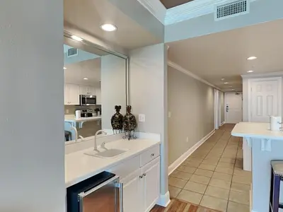a kitchen with a sink and a mirror at Majestic Beach Towers II #1806 in Panama City Beach