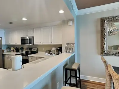 a kitchen with white cabinets and a counter top at Majestic Beach Towers II #1806 in Panama City Beach
