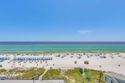an aerial view of a beach with umbrellas and the ocean at Beach and Pool Access Regency Towers Condo in PCB! in Panama City Beach