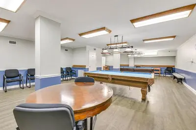 a conference room with a pool table and chairs at Beach and Pool Access Regency Towers Condo in PCB! in Panama City Beach