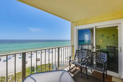 a balcony with chairs and a view of the beach at Beach and Pool Access Regency Towers Condo in PCB! in Panama City Beach