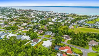 an aerial view of a neighborhood with houses and the ocean at Pet Friendly Beach House - Baby Blue Heron by Panhandle Getaways in Panama City Beach