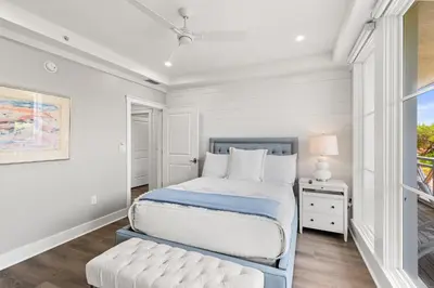a white bedroom with a bed and a window at A115 The Fuller View at Watersound in Santa Rosa Beach