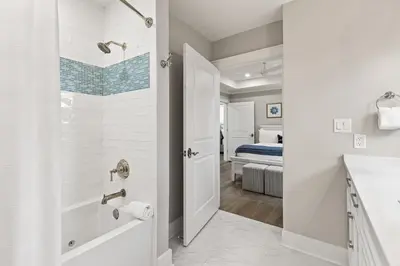a bathroom with a walk in shower and a sink at A115 The Fuller View at Watersound in Santa Rosa Beach
