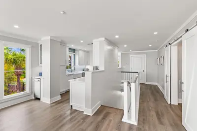 a kitchen with white walls and hardwood floors at A115 The Fuller View at Watersound in Santa Rosa Beach