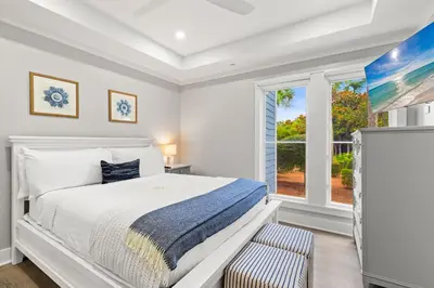 a white bedroom with a bed and a window at A115 The Fuller View at Watersound in Santa Rosa Beach
