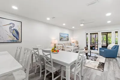 a dining room with a white table and chairs at Wise Choice on 30A in Santa Rosa Beach
