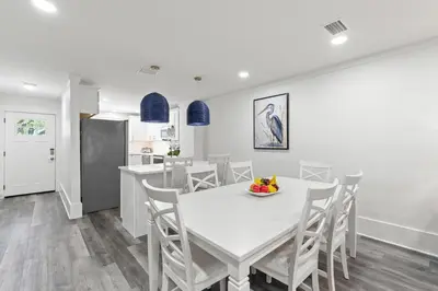 a kitchen and dining room with a white table and chairs at Wise Choice on 30A in Santa Rosa Beach