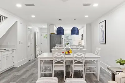 a kitchen and dining room with a white table and chairs at Wise Choice on 30A in Santa Rosa Beach