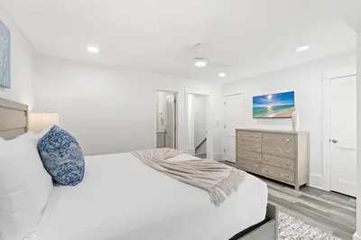 a white bedroom with a bed and a dresser at Wise Choice on 30A in Santa Rosa Beach