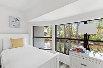 a white bedroom with a bed and a window at Wise Choice on 30A in Santa Rosa Beach
