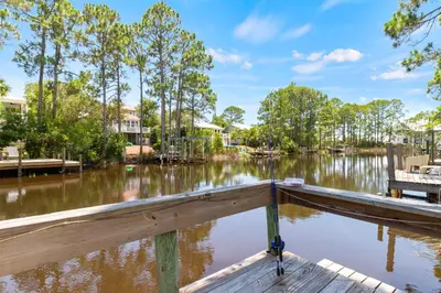 a dock in a body of water with trees at Wise Choice on 30A in Santa Rosa Beach