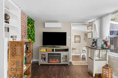 a living room with a television and a fireplace at Down By The Bay St Andrews Gem in Panama City