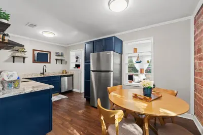 a kitchen with a table and a stainless steel refrigerator at Down By The Bay St Andrews Gem in Panama City