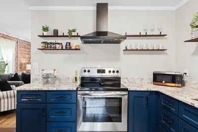 a kitchen with blue cabinets and a stove at Down By The Bay St Andrews Gem in Panama City