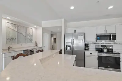 a kitchen with white cabinets and a white counter top at Legacy 202 in Santa Rosa Beach
