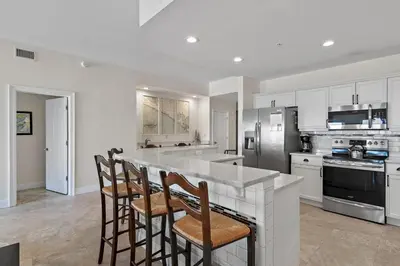a kitchen with a large island with bar stools at Legacy 202 in Santa Rosa Beach