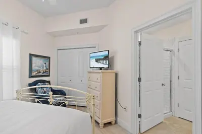 a bedroom with a bed and a tv on a dresser at Legacy 202 in Santa Rosa Beach