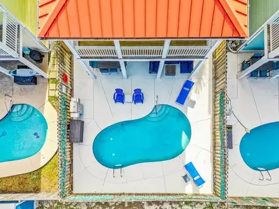 an overhead view of a pool with chairs and tables at PCB Private Pool Home, Sleeps 14, Dog Friendly, Near Beach in Panama City Beach