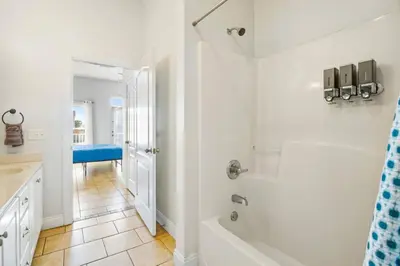 a white bathroom with a tub and a shower at PCB Private Pool Home, Sleeps 14, Dog Friendly, Near Beach in Panama City Beach