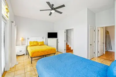 a bedroom with a bed and a ceiling fan at PCB Private Pool Home, Sleeps 14, Dog Friendly, Near Beach in Panama City Beach