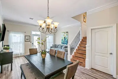 a dining room with a table and a couch at Beach House w/ Private Pool Near PCB | Dog Friendly in Panama City Beach