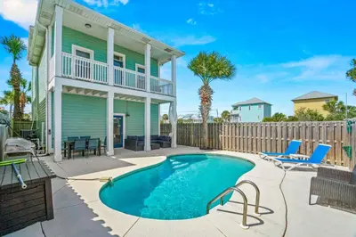 a swimming pool in front of a house at Beach House w/ Private Pool Near PCB | Dog Friendly in Panama City Beach