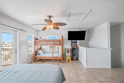 a bedroom with a bed and a ceiling fan at Beach House w/ Private Pool Near PCB | Dog Friendly in Panama City Beach