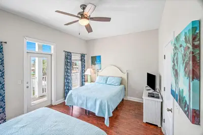 a bedroom with a bed and a ceiling fan at Beach House w/ Private Pool Near PCB | Dog Friendly in Panama City Beach