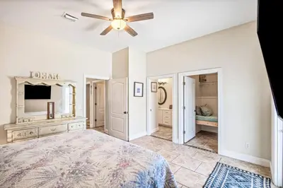 a bedroom with a bed and a ceiling fan at Beach House w/ Private Pool Near PCB | Dog Friendly in Panama City Beach