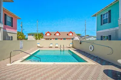 a swimming pool in front of a house at Dog-Friendly 3BR Beach Retreat | Walk to Shore & Community Pool in Panama City Beach