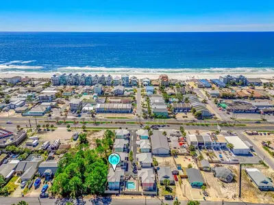 an aerial view of a parking lot next to the ocean at Dog-Friendly 3BR Beach Retreat | Walk to Shore & Community Pool in Panama City Beach