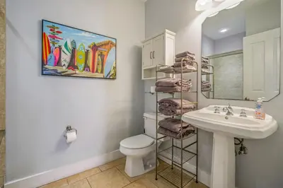 a bathroom with a sink and a toilet and a mirror at Dog-Friendly 3BR Beach Retreat | Walk to Shore & Community Pool in Panama City Beach