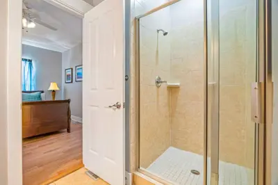 a bathroom with a shower with a glass door at Dog-Friendly 3BR Beach Retreat | Walk to Shore & Community Pool in Panama City Beach