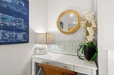 a white desk with a mirror and a lamp at Dog-Friendly 3BR Beach Retreat | Walk to Shore & Community Pool in Panama City Beach