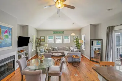 a living room with a couch and a table at Dog-Friendly 3BR Beach Retreat | Walk to Shore & Community Pool in Panama City Beach