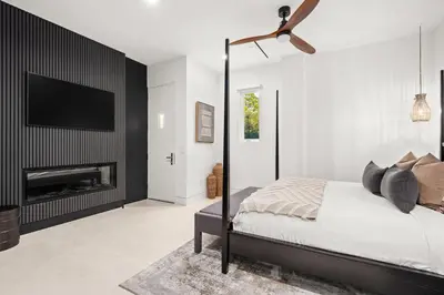 a bedroom with a bed and a tv on a wall at 30a Gulf-View Gem | Stay Gold in Santa Rosa Beach