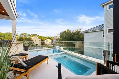 a swimming pool on a balcony with a house at 30a Gulf-View Gem | Stay Gold in Santa Rosa Beach