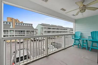 a balcony with chairs and a view of a parking lot at Quiet West End PCB Condo w/ Gulf Views, Pool & Easy Beach Access in Panama City Beach