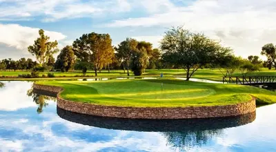 a golf course with a reflection in the water at Quiet West End PCB Condo w/ Gulf Views, Pool & Easy Beach Access in Panama City Beach